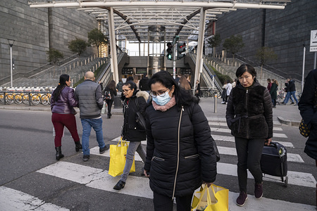 A woman wearing a face mask crossest the street at Porta Garibaldi Station.
Precautionary measures, such as wearing face masks have been taken by citizens and tourists in Milan, for dealing with the fear of being infected by Coronavirus (COVID -19), as more than one hundred confirmed cases have been discovered in north Italy and three old people died. According to a regional decree, many activities (educational, cultural, museum tours etc) will be suspended until 1st or 2nd March; thus, people reacted with a massive rush to buy water, food supply and soaps.
