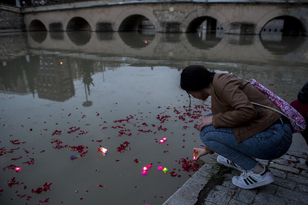 A girl puts a candle into the Genil River river during the International Roma Day. People from Granada (Spain) take part in the “River Ceremony” on April 6th, an act of the International Roma Day, celebrated each April 8th around the world since 1990. It commemorates the first World Romani Congress, celebrated in Chelsfield near London in 1971