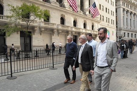 People walk past the New York Stock Exchange in the Financial District in Manhattan, New York City.