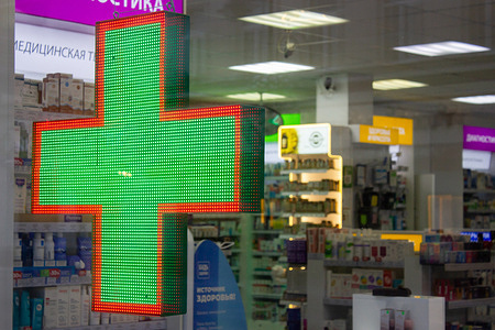 View of a green cross sign on pharmacy shop window in Moscow. Russian Industry and Trade Ministry said the U.S. pharmaceutical corporation Viatris which owns the Viagra brands, had suspended deliveries of the erectile dysfunction pill to Russia. Many pharmacies in Moscow quickly ran out of stock for Viagra.