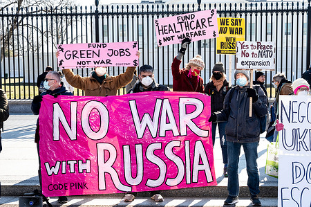 Protesters holding banners and placards saying "Fund Green jobs, not war", "Fund healthcare, not warfare", "We say no war with Russia", "Yes to peace, no to NATO expansion", and "No war with Russia" at a rally against war with Russia sponsored by multiple groups including CODEPINK: Women for Peace, Black Alliance for Peace, ANSWER, and Maryland Peace Action at the White House.