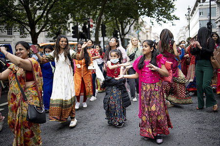 Young Hindu devotees seen dancing and chanting Hare Krishna during a Parade.
Thousands of religious Hindu followers gathered in central London to celebrate Rathayatra on the street. The parade usually consists of three chariots representing the Hindu deities however due to COVID-19 restriction, only one chariot was allowed this year.