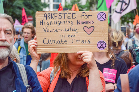 A protester holds a placard which says Arrested For Highlighting Women's Vulnerability in the Climate Crisis during the demonstration in Cheapside.
Extinction Rebellion protesters marched through the City of London to the Bank of England, part of their two-week Impossible Rebellion campaign calling on the UK Government to act meaningfully on the climate and ecological crisis.