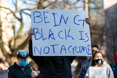 A protester holds a placard reading "being black is not a crime." during a protest march.
The 3/20 Coalition organized a protest march demanding justice and to mark the second anniversary of Osaze Osagie being shot and killed by State College police at his apartment.