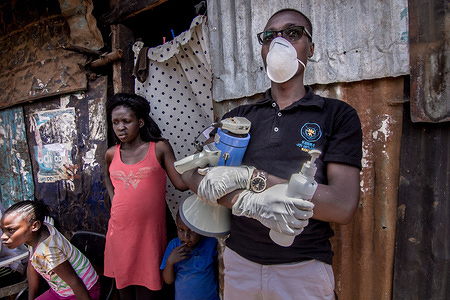 A local health worker wearing a protective mask and gloves sensitises residents on how to stay safe and be aware of Coronavirus.
Kenya Coronavirus cases rise to 38 as 7 new infections are confirmed.