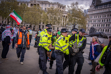 A protestor was carried away by police during the Lift The Ban on Palestine Action Protest at London's Trafalgar Square. Defend Our Juries and partner organisations called on everyone to join together holding the same signs as before in Trafalgar Square. The courts must Lift The Ban on Palestine Action, and drop all charges and investigations into the almost 3,000 people who have been arrested under the Terrorism Act for allegedly supporting the group since the proscription came into effect. The UK Government must end its complicity in Israel’s genocide.