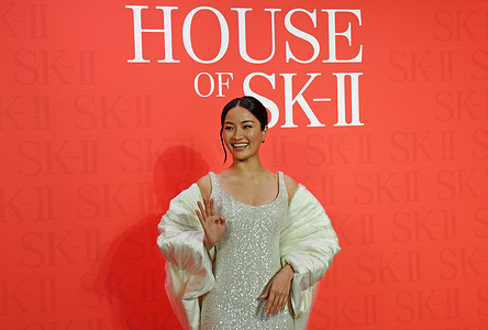 Japanese actress and singer Anna Sawai waves to the media (not in photo) as she poses for a photo at the launch of Japanese skincare brand SK-II in Mumbai.