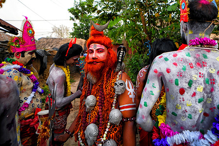 Hindu devotees seen waiting to take part in the annual Gajan Festival. Gajan is a Hindu festival celebrated mainly in rural West Bengal, lasting about a week and starting in mid-April. Participants, known as Sannyasis or devotees, express their devotion through acts of sacrifice and non-sexual pain. The festival emphasizes spiritual satisfaction through endurance and faith. It holds deep cultural and religious significance in the region.