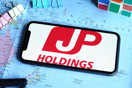 In this photo illustration, a Japan Post logo is displayed on the screen of a smartphone.