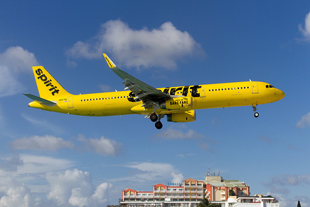 A Spirit Airlines Airbus 321 seen landing at airport Princess Juliana just over Maho beach.