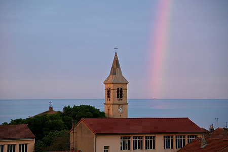 A rainbow is seen above a church in Marseille.