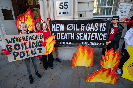 Environmental activists hold placards and banners expressing their opinion during a demonstration outside the Department for Energy Security and Net Zero in London. Members of the environmental pressure group Fossil Free London activists stage a creative action outside DESNZ (Department for Energy Security Net Zero in London, protesting against the expansion of North Sea oil and gas fields, including the proposed Rosebank development. Protesters dressed in red and wearing lobster antennae gathered around a large lobster pot alongside chefs, in a visual stunt highlighting concerns over the environmental impact of continued fossil fuel extraction. Protesters carried Stop Rosebank and Stop Jackdaw placards.