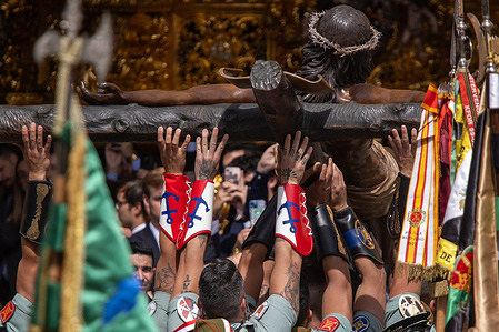 A group of legionnaires carry the Christ of Mena during the transfer of the Christ of Mena on Holy Thursday, one of the most famous Holy Week processions in all of Spain, both for what it represents and for the participation of the Legion singing "El Novio de la Muerte", an emblematic song that has become the unofficial anthem of the Spanish Legion.