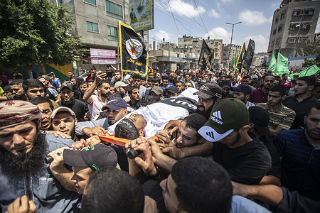 (EDITORS NOTE image depicts death) 
Mourners carry the body of 22-years-old Palestinian Anas Inshasi, during his funeral in Khan Yunis in the southern Gaza Strip, who died of wounds sustained during the violence between Israel and Islamic Jihad.