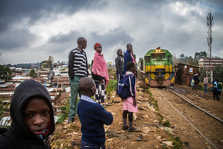 Residents wait to board the morning passengers train at a normal train stop in Kibera.
Inside Africa’s largest Slums of Kibera lives a population of about one million Kenyan Citizens. It’s a hideout to the rising population of the poor who are looking for a cheap and sustainable life. The rate of crime and teenage pregnancies among others is high due to unemployment. As all poor communities, people here mostly believe in togetherness and happiness despite of all the challenges.