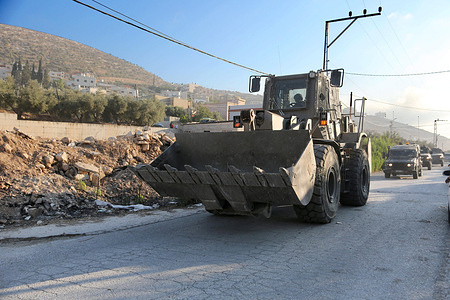 Israeli military vehicles withdraw after completing the demolition of the family home of Palestinian prisoner Dawas Hassoun. Israeli army forces demolished the family home of Palestinian prisoner Dawas Hassoun in the village of Beit Marin northwest of Nablus in the West Bank, he is accused of killing an Israeli settler.