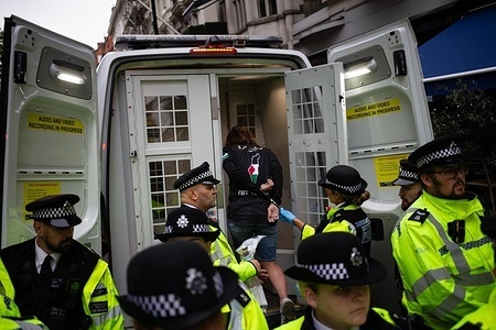 A protester is arrested and led into the back of a police van during the demonstration. Thousands took to the streets to call on the UK government to cease any weapons being supplied to Israel, and an ultimate end to the current conflict in the region.