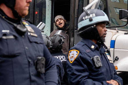 A students sings as he is being put on the NYPD bus. Pro-Palestine students at Columbia University who set up a “Gaza Solidarity Encampment” on the campus the day before are arrested after Columbia directed NYPD to clear them out.