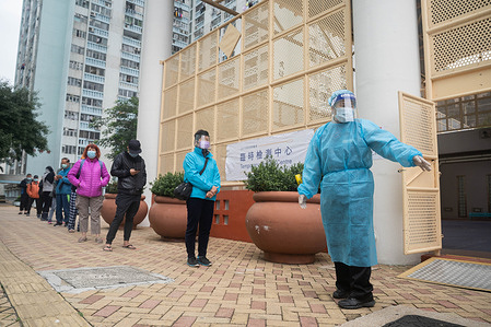 A health worker seen dressed up in her PPE (Personal Protective Equipment) as residents from a public housing estate line up to have their Covid-19 swab test done at a makeshift Covid-19 testing centre.
Multiple makeshift Covid-19 coronavirus testing centres are set up in Hong Kong to provide free of charge testing services for residents.