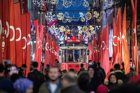 People were seen walking with the nostalgic tram between the flags. Turkish flags are put along Istiklal Avenue after the deadly terror attack in Beyoglu, Istanbul.