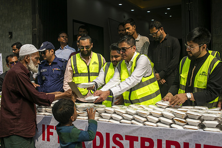 Bangladeshi journalist, writer, and talk show host Khaled Muhiuddin (R) distributes free food donated by charitable organization Bhalo during the holy month of Ramadan in Narayanganj city. A charitable organization Bhalo run by Bangladeshis in New York . “Bhalo” is distributing free iftar meals every day to 1,200 underprivileged people in Narayanganj city.