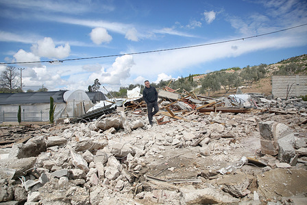 Palestinians inspect the rubble of a house and shop demolished by Israeli bulldozers in the village of Zawiya, south of Jenin in the West Bank. The bulldozers destroyed the family's home and shop. Palestinian sources reported that the Israeli government is seeking to annex Palestinian Authority-owned land and is working to annex the West Bank.