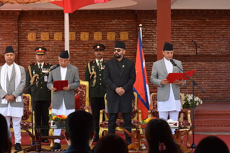 Nepal's President Ram Chandra Poudel (L) administers the oath of office to Nepal's newly elected Speaker of the House of Representatives Dol Prasad Aryal in presents of Prime Minister Balendra Shah (C) during a swearing-in ceremony at Shital Niwas, the presidential office.