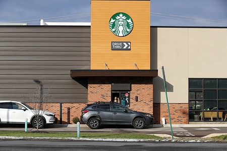 A Starbucks worker assists a customer at the drive thru window. Starbucks Workers United announced that more than 1,000 baristas at about 100 locations would strike for three days starting on December 16. Workers at the location in Bloomsburg did not participate in the strike.
