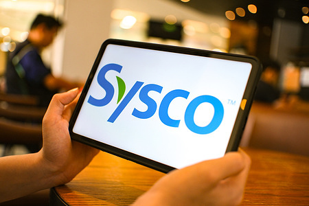 In this photo illustration, the Sysco logo is seen displayed on a tablet screen.