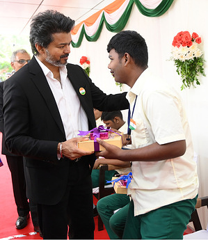 Chandrasekaran Joseph Vijay, chief minister of Tamil Nadu distributes sweets to physically challenged boy during the event. Tamil Nadu Chief Minister Vijay hoists the national flag during Independence Day celebrations in Chennai, Tamil Nadu, and The Chief Minister also presented awards to individuals in recognition of their distinguished service and contributions across various fields.