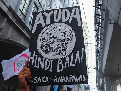 A protester holds a placard expressing her opinion during the demonstration. Militant groups staged a protest in Manila in connection with Ferdinand Marcos Jr. 100 days in power as Philippine President.