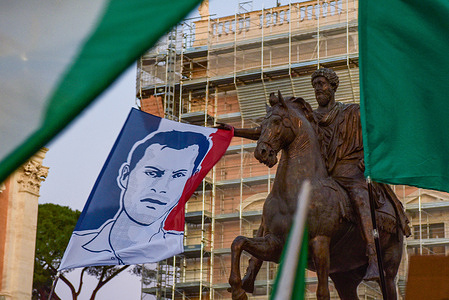 A flag displaying the face of Quentin Deranque is carried during the march against political violence from Largo di Torre Argentina to Piazza del Campidoglio.