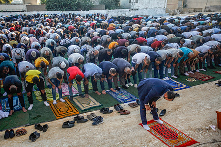 Palestinian Muslims perform the Eid prayers on the first day of Eid al-Adha, in the town of Beit Furik, east of the city of Nablus in the occupied West Bank. Eid al-Adha or the Great Eid is one of the important holidays for Muslims and is associated with the slaughter of sheep and cattle.