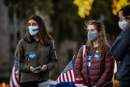 Young students female voters with Biden/Harris stickers.
On the University of Pittsburgh campus many students organizing get out the vote campaigns through signs, stickers, and text messaging their friends during the United States Election Day.