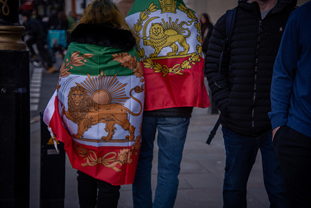 Protestors seen wrapped in the Iranian flag . The Global Day of Action against the Iranian Regime.