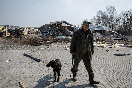 Airfield security is seen with his dog at the AEROTIM Buzovaya Airfield in Kyiv Oblast. Russia invaded Ukraine on 24 February 2022, triggering the largest military attack in Europe since World War II.