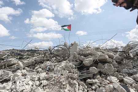 A Palestinian flag seen flying over a destroyed house of a Palestinian family in the village of Anza, south of Jenin in the West Bank. The Israeli bulldozers demolished the Palestinian home, which is located in an area under the control of the Palestinian Authority, headed by President Mahmoud Abbas. The UN Special Rapporteur on the situation of human rights in the Palestinian territories, Francesca Albanese, condemned Israel's expansion of land confiscation in the West Bank.