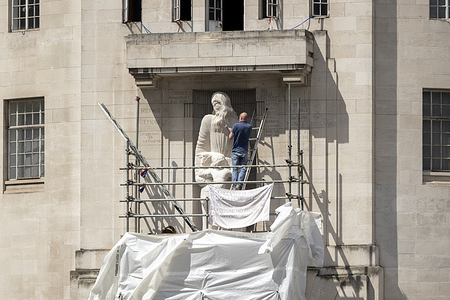 A protester is seen hammering the Eric Gill's Prospero and Ariel Statue outside Broadcasting House. A man climbed the scaffolding outside the Broadcasting House and damaged the controversial statue of Eric Gill's Prospero and Ariel Statue. The man calls for the statue's removal because the sculptor (Eric Gill) is known for abusing his daughters and had an incestuous relationship with his sister, as recorded in Gill's diary. In January, a protest was also held and caused damages to the statue.
