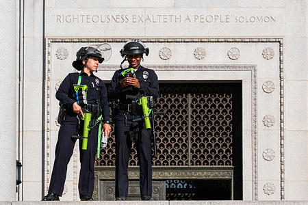 Two police officers guard the Los Angeles City Hall during a demonstration over President Donald Trump’s immigration policies. Trump has sent the California National Guard and U.S. Marines to Los Angeles City Hall over the objection of the governor and mayor.