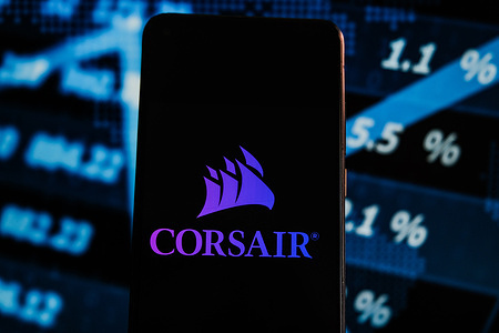 In this photo illustration a Corsair logo displayed on a smartphone with stock market percentages on the background.