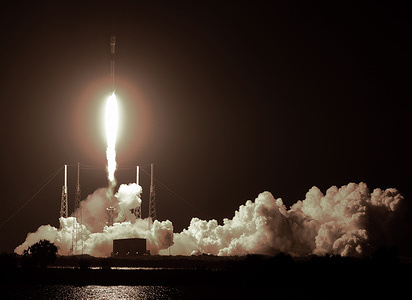 A SpaceX Falcon 9 rocket carrying approximately 60 Starlink satellites lifts off from pad 40 at Cape Canaveral Space Force Station. The satellites are part of a constellation designed to provide broadband internet service around the globe.