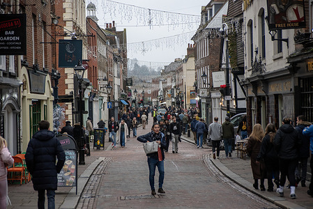 People walk on the High Street in Rochester. Rochester is a port town in the unitary authority of Medway, in Kent, England. It is at the lowest bridging point of the River Medway, about 30 miles east-southeast of London.
