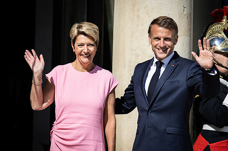 The French President Emmanuel Macron (R) welcomes the President of the Swiss Confederation Karin Keller-Sutter (L) at the entrance of the Elysée Presidential Palace.