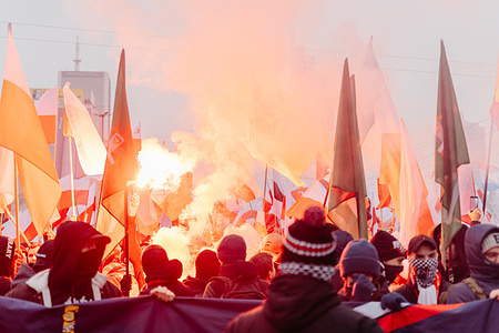 Crowds march carrying Polish flags and lighting white and red flares during Independence Day celebrations marking the 107th anniversary. The Polish celebrate National Independence Day commemorating the country's regaining of independence in 1918 after 123 years of partition. For 16 years, an independence march organized by the nationalist and right-wing Independence March Association takes place annually through the streets. This year, the march is held under the slogan 'One Nation - Strong Poland,' and the event extensively addresses the issue of migration as a threat to national unity.