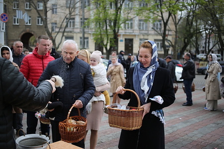 Parishioners and a priest seen during the food consecration ceremony. Easter celebration at the Transfiguration Cathedral to celebrate the Resurrection of Christ, the Bright Resurrection of Christ is the oldest and most important Christian holiday. Established in honor of the Resurrection of Jesus Christ, which is the center of all biblical history and the basis of all Christian teaching.