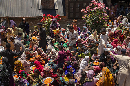 Kashmiri devotees belonging to nomadic Gujjar and Bakarwal tribe receive sweetened rice outside the forest shrine of Sufi saint Mian Nizamuddin Kiyanwi northeast of Srinagar, Indian-administered Kashmir. Every year, tens of thousands of Gujjar and Bakarwal Muslims from across Kashmir and neighbouring regions travel to the forested mountain shrine for the annual Urs, a commemoration of the saint's death anniversary and one of the largest spiritual gatherings of the Himalayan pastoral community. Rooted in centuries old Sufi traditions, the event is both a religious observance and a celebration of cultural identity, bringing together nomadic families separated by seasonal migration while preserving oral histories, cultural traditions and migratory knowledge passed down through generations. The shrine is a spiritual centre for many Gujjars and Bakarwals, and operates a free community kitchen throughout the year for devotees and visitors. During the two day gathering, worshippers participate in night long prayers, Quran recitations and religious sermons before the Urs concludes with special collective prayers for peace, prosperity and communal harmony.