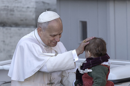 Pope Leo XIV greets a little girl at the end of a Mass on the occasion of the Jubilee of Choirs at St. Peter's Square.