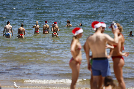 Families and friends enjoy a warm Christmas Day by the water at St Kilda Beach, embracing the summer season. Melbourne celebrates a summer Christmas as crowds gather at St Kilda Beach to enjoy sunshine, festive cheer, and holiday traditions.