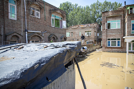 Partially submerged houses are seen as water levels rise in the River Jhelum after heavy rains on the outskirts of Srinagar. Torrential rains pushed the river past the danger mark, prompting authorities to declare a flood. Authorities have closed all educational institutions and shut the Srinagar-Jammu main highway, the only road link connecting the Kashmir Valley with the rest of India.