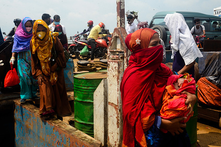 Migrant garment workers disembark from a ferry after their arrival at Mawa ferry ghat.The government of Bangladesh has eased the restrictions over transportation and reopened garment factories amid coronavirus crisis.
